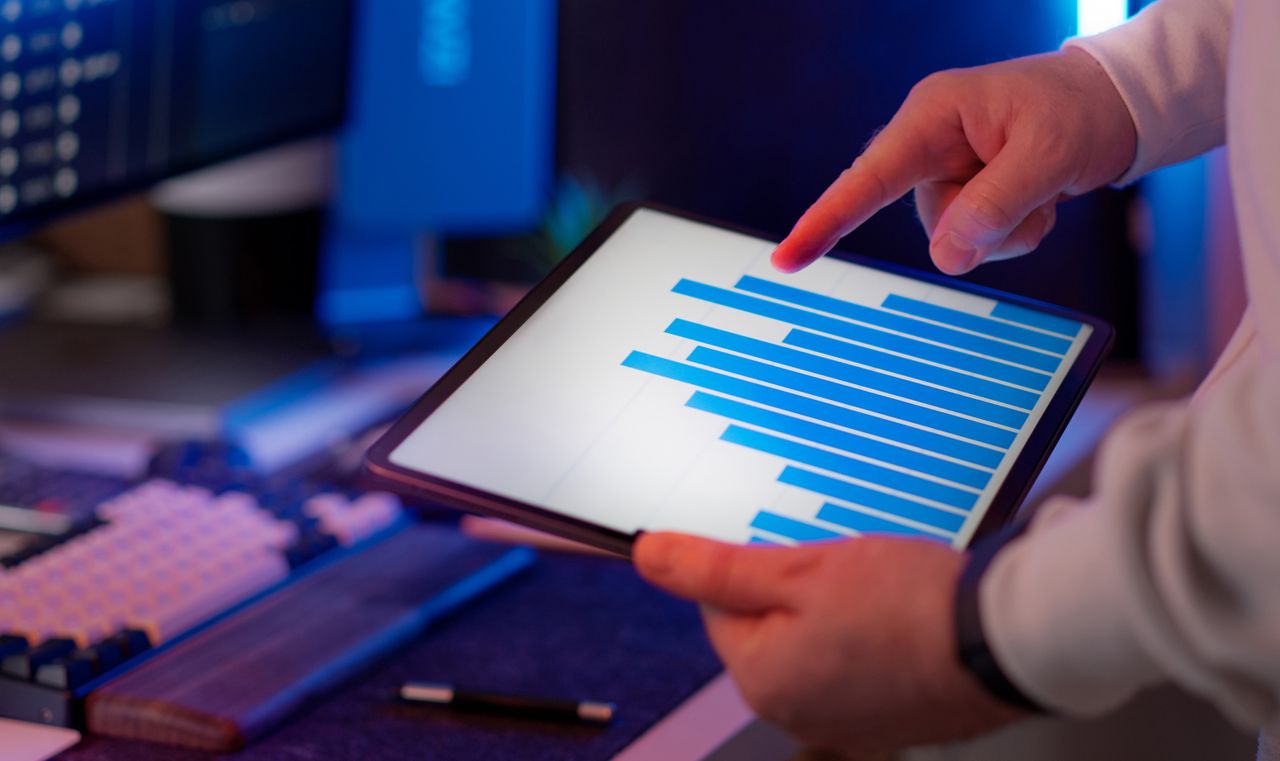 Crafting Captivating Headlines: Your awesome post title goes here Business professional analyzing bar chart on tablet in office setting, highlighting data insights.